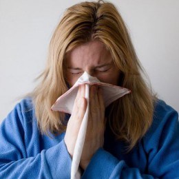 woman blowing her nose