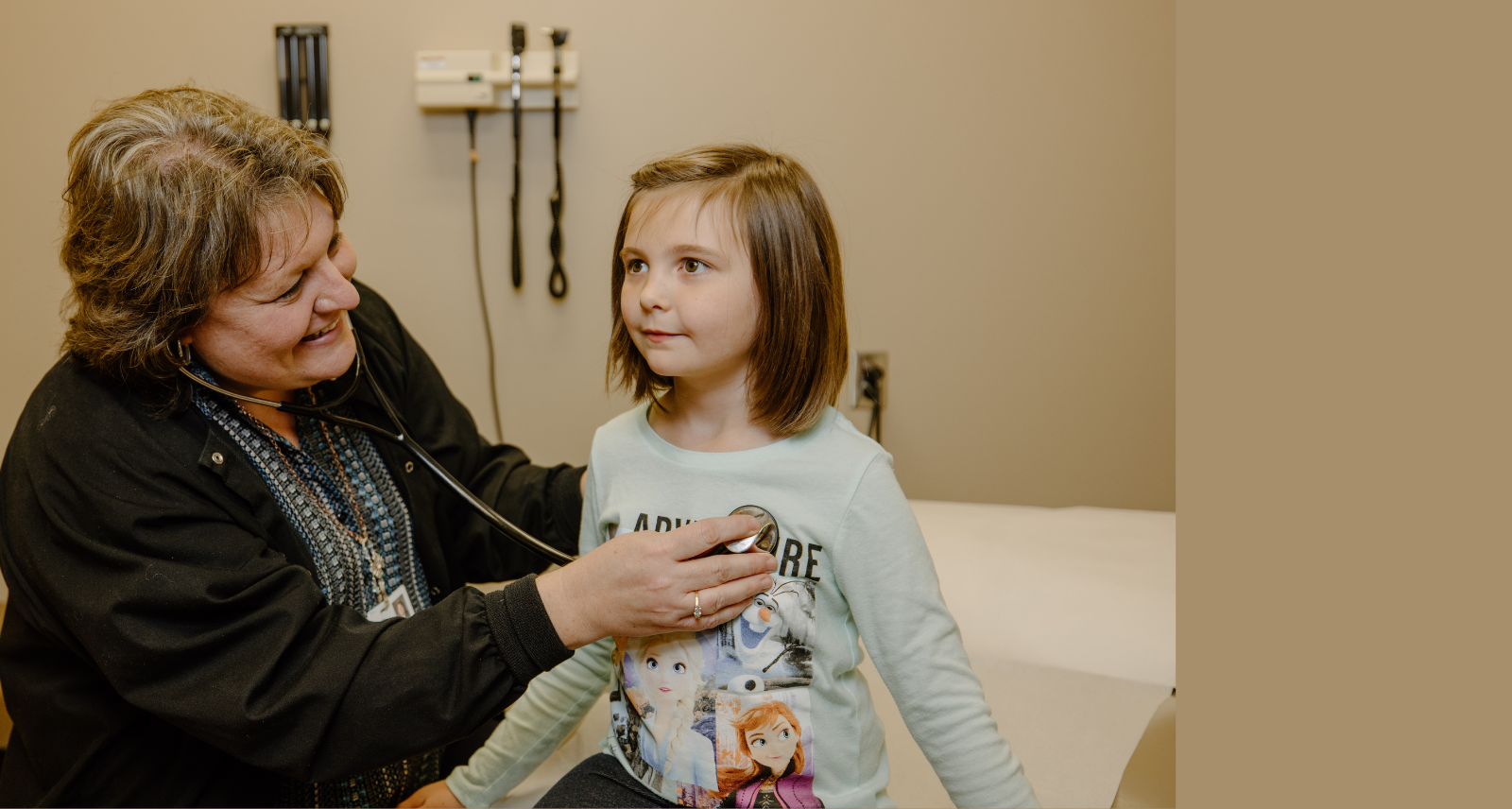 doctor checking girl's heart