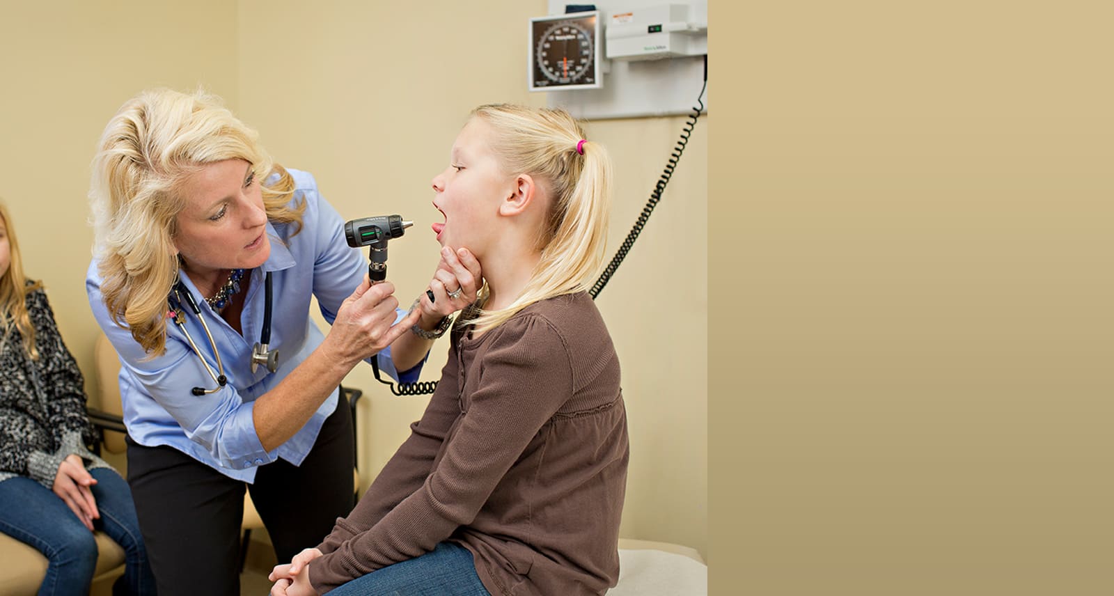 doctor checking young girl's throat